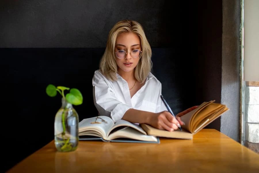 Zena sjedi za stolom i cita